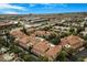 Stunning aerial view of townhomes with a terracotta roof, surrounded by lush landscaping and a community pool at 8653 E Royal Palm Rd # 1006, Scottsdale, AZ 85258