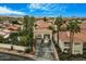 Aerial view of a gated community with palm trees, landscaping, and red tile roofs at 8653 E Royal Palm Rd # 1006, Scottsdale, AZ 85258