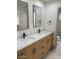 Modern bathroom with double vanity, white marble countertops, and sleek black fixtures at 8653 E Royal Palm Rd # 1006, Scottsdale, AZ 85258