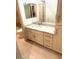 A bathroom featuring white cabinets, granite countertops, and a stylish mirror at 8653 E Royal Palm Rd # 1006, Scottsdale, AZ 85258