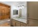 Well-lit bathroom with a shower-tub combo and a marble countertop at 8653 E Royal Palm Rd # 1006, Scottsdale, AZ 85258