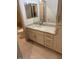 Bathroom vanity with light countertop, drawers, and cabinets, complemented by a framed mirror at 8653 E Royal Palm Rd # 1006, Scottsdale, AZ 85258