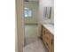 Bathroom features light wood vanity cabinets and an open doorway at 8653 E Royal Palm Rd # 1006, Scottsdale, AZ 85258