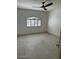 Bright bedroom with ceiling fan, neutral walls, and large window for natural light at 8653 E Royal Palm Rd # 1006, Scottsdale, AZ 85258