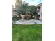 Three-tiered fountain surrounded by green grass and community buildings at 8653 E Royal Palm Rd # 1006, Scottsdale, AZ 85258