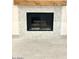 Close up of a fireplace featuring a herring bone tile surround and wood mantel at 8653 E Royal Palm Rd # 1006, Scottsdale, AZ 85258