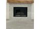 Close-up view of fireplace with marble backsplash and wooden beam mantle at 8653 E Royal Palm Rd # 1006, Scottsdale, AZ 85258