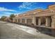 View along the street of the building garages with arched entryways and red-tiled roofs at 8653 E Royal Palm Rd # 1006, Scottsdale, AZ 85258