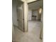 Hallway leading to a brightly lit room featuring neutral-colored walls and floors at 8653 E Royal Palm Rd # 1006, Scottsdale, AZ 85258