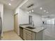 Modern kitchen island featuring granite countertops, stylish pendant lighting, and stainless steel appliances at 8653 E Royal Palm Rd # 1006, Scottsdale, AZ 85258