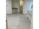 Spacious living space with light tile flooring, featuring a wet bar and bright, open layout at 8653 E Royal Palm Rd # 1006, Scottsdale, AZ 85258