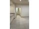 Open-concept living space featuring tile flooring with a doorway leading to the bathroom at 8653 E Royal Palm Rd # 1006, Scottsdale, AZ 85258