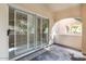 View of the outdoor patio with sliding glass doors and window shutters to bring light into the house at 8653 E Royal Palm Rd # 1006, Scottsdale, AZ 85258