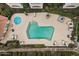 Aerial view of the pool area with a large pool, landscaping, and lounge chairs at 8653 E Royal Palm Rd # 1006, Scottsdale, AZ 85258