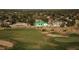 Scenic aerial view of a white home overlooking a golf course with mature trees in the background at 9440 N 57Th St, Paradise Valley, AZ 85253