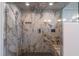 Luxurious shower with glass door, marble tiling, and sleek fixtures for a spa-like experience at 9440 N 57Th St, Paradise Valley, AZ 85253