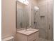 Bathroom featuring a vanity with a marble countertop and a tiled walk-in shower with a glass door at 9440 N 57Th St, Paradise Valley, AZ 85253