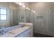 Well-lit bathroom with dual sinks, marble countertops, and a frameless glass shower, providing a spa-like experience at 9440 N 57Th St, Paradise Valley, AZ 85253