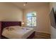 Charming bedroom featuring a floral-patterned bedspread and a large window with a view of the neighborhood at 9440 N 57Th St, Paradise Valley, AZ 85253