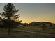 Scenic view of a golf course with mountains in the background at sunset at 9440 N 57Th St, Paradise Valley, AZ 85253