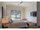 Cozy bedroom with a sliding glass door to the backyard, featuring a plush bed and modern decor at 9440 N 57Th St, Paradise Valley, AZ 85253