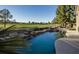 Backyard swimming pool with rock waterfall feature and golf course views at 9440 N 57Th St, Paradise Valley, AZ 85253