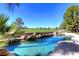 Inviting pool area with rock features and a view of the golf course, perfect for relaxation at 9440 N 57Th St, Paradise Valley, AZ 85253