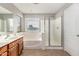 Bright bathroom featuring a soaking tub, walk-in shower, and wood vanity at 9545 W Williams St, Tolleson, AZ 85353