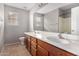 Bathroom featuring double sink vanity, tile floors, large mirror, and a shower with tub at 9545 W Williams St, Tolleson, AZ 85353