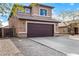 Two story home with a large two car garage, rock accents, and a well manicured front yard at 9545 W Williams St, Tolleson, AZ 85353