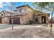 Two story home with a large two car garage, rock accents, and a well manicured front yard at 9545 W Williams St, Tolleson, AZ 85353