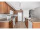 Bright kitchen with wooden cabinets, white appliances, and neutral countertops at 9545 W Williams St, Tolleson, AZ 85353