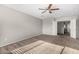 Large carpeted main bedroom with a ceiling fan, neutral paint and two doors to a bathroom and closet at 9545 W Williams St, Tolleson, AZ 85353