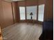 Bright bedroom featuring wood-look floors, triple windows and a closet with sliding doors at 9828 E Pueblo Ave # 67, Mesa, AZ 85208