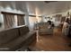 Comfortable living room featuring an arm chair, sofas, wood-look floors, and natural light streaming through a window at 9828 E Pueblo Ave # 67, Mesa, AZ 85208