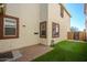 The backyard has a brick patio and grassy area for entertaining and relaxing at 10219 E Isleta Ave, Mesa, AZ 85209