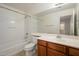 Bright bathroom showcasing a shower-tub combo, a vanity with storage, and a tile floor at 10219 E Isleta Ave, Mesa, AZ 85209