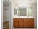 Well-lit bathroom with double sink vanity and nearby walk-in closet offers modern elegance at 10219 E Isleta Ave, Mesa, AZ 85209