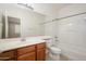 Bright bathroom featuring a tub and shower, vanity, toilet, and tiled floors at 10219 E Isleta Ave, Mesa, AZ 85209