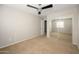 The bedroom features a ceiling fan, sliding mirror closet doors, and a window providing natural light at 10219 E Isleta Ave, Mesa, AZ 85209