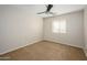 The bedroom includes a ceiling fan, carpeted floor, neutral paint, and a window with blinds at 10219 E Isleta Ave, Mesa, AZ 85209