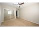 Bedroom with carpet, neutral walls, ceiling fan and closet with mirrored sliding doors at 10219 E Isleta Ave, Mesa, AZ 85209