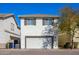 Two-story home with a two car garage, brick driveway and landscaped yard at 10219 E Isleta Ave, Mesa, AZ 85209