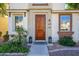 Inviting front entrance with a solid wood door, stylish lanterns, manicured landscaping, and clear address display at 10219 E Isleta Ave, Mesa, AZ 85209