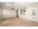 Open-concept living space showcasing neutral decor, carpet flooring, and seamless transition to the kitchen area at 10219 E Isleta Ave, Mesa, AZ 85209