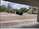 View from garage of brick-paved parking area with assigned parking spot and desert landscaping at 10219 E Isleta Ave, Mesa, AZ 85209