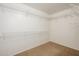 Spacious walk-in closet featuring white wire shelving, and neutral carpet providing ample storage space at 10219 E Isleta Ave, Mesa, AZ 85209