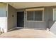 Inviting covered front porch featuring a secure door and window, offering a cozy outdoor space at 10392 W Deanne Dr, Sun City, AZ 85351