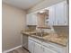 Kitchen featuring a stainless steel sink, granite countertops and white cabinetry at 10392 W Deanne Dr, Sun City, AZ 85351