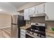 Kitchen featuring stainless steel appliances, a black cooktop, and granite counters at 10392 W Deanne Dr, Sun City, AZ 85351